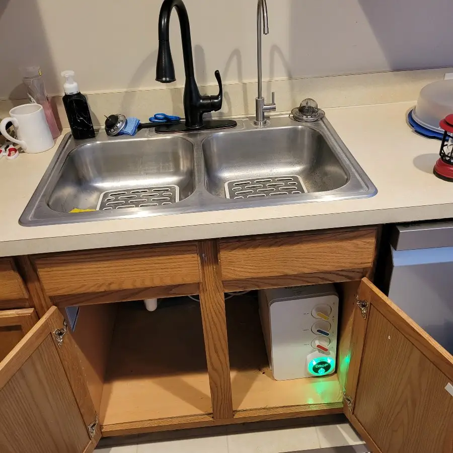 Kitchen sink with under-cabinet water treatment system visible. This image showcases "Water Treatment" installation